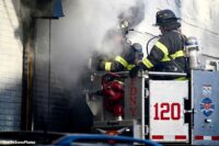 FDNY firefighters in a bucket with smoke