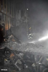 Firefighter amid the ruins of a house fire