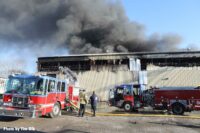 Fire trucks and smoke at industrial site