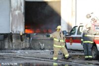 Firefighters with flames inside a loading dock