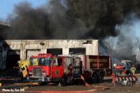 Fire apparatus with dark smoke above them