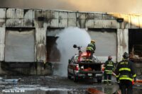 Firefighter uses cannon to blast foam into building