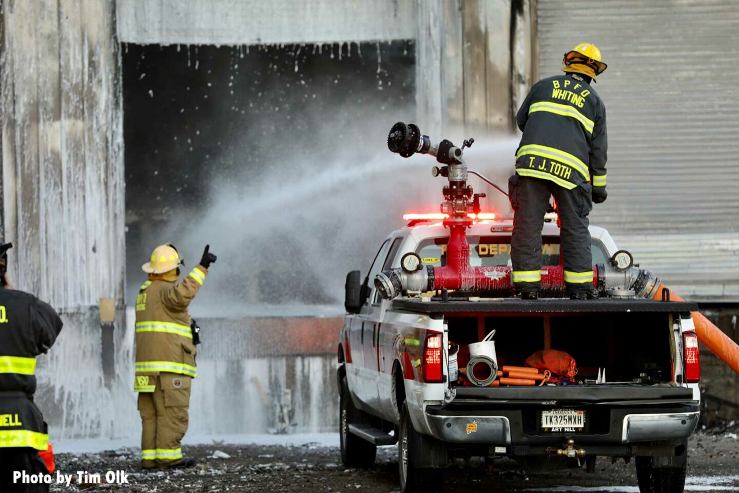 Truck-mounted foam cannon being used on fire