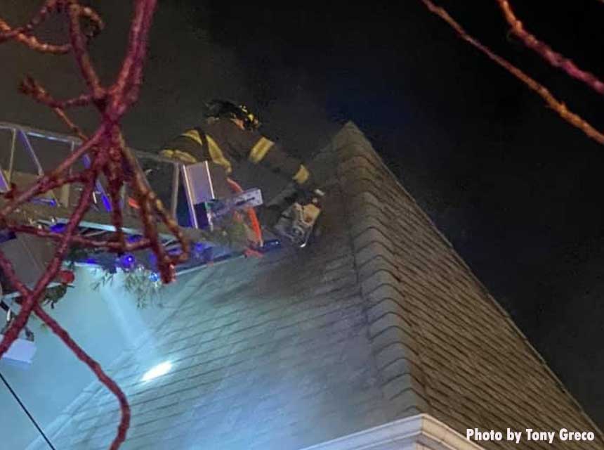 Firefighter cuts from the bucket during a house fire in Hasbrough Heights