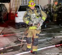 LAFD firefighter carrying a rescued dog