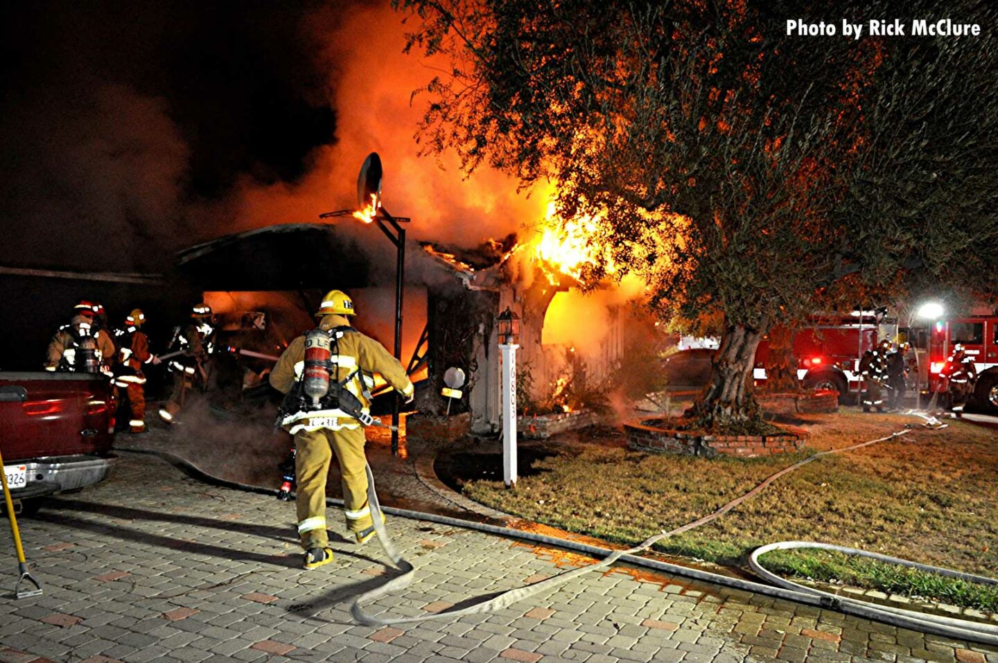 LAFD firefighters pull lines at a raging structure fire