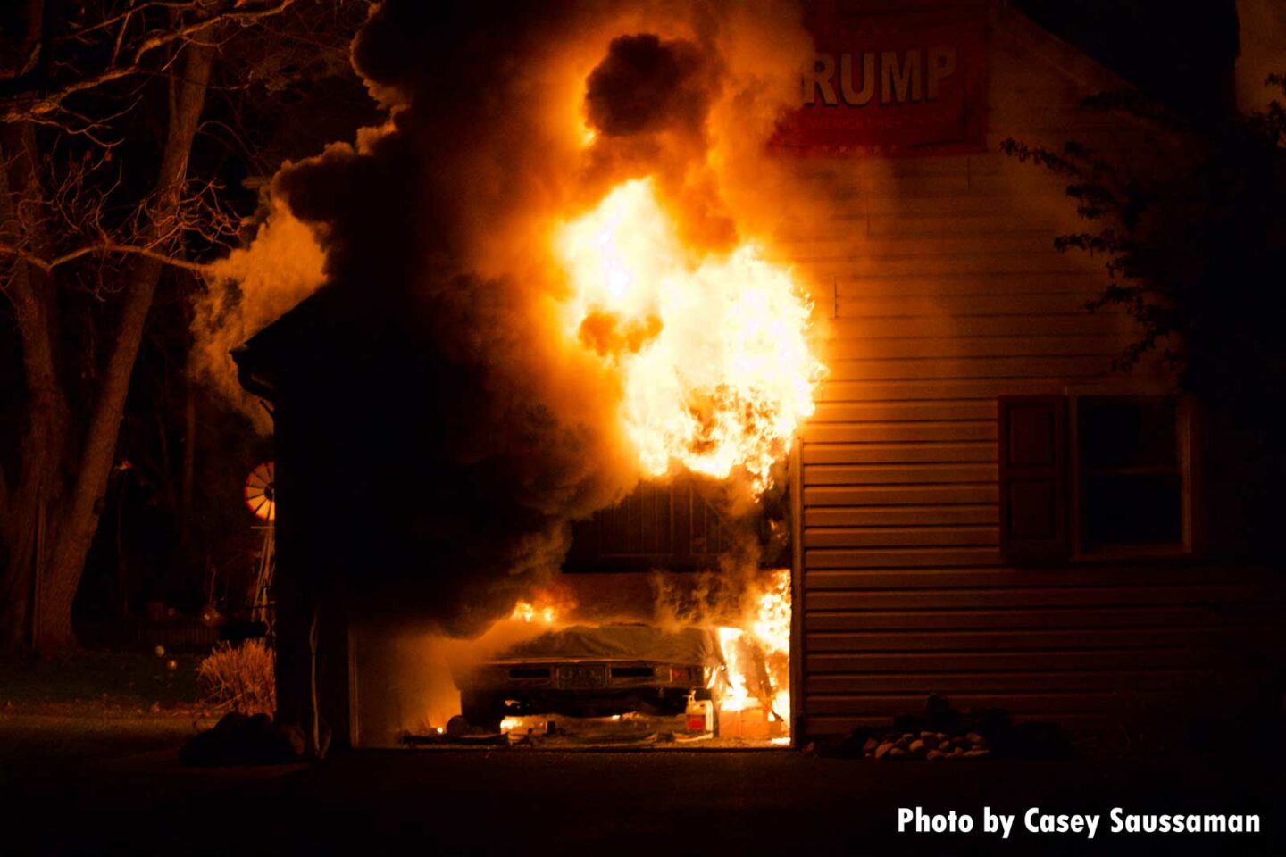 Photos show flames tearing through the garage and a vehicle