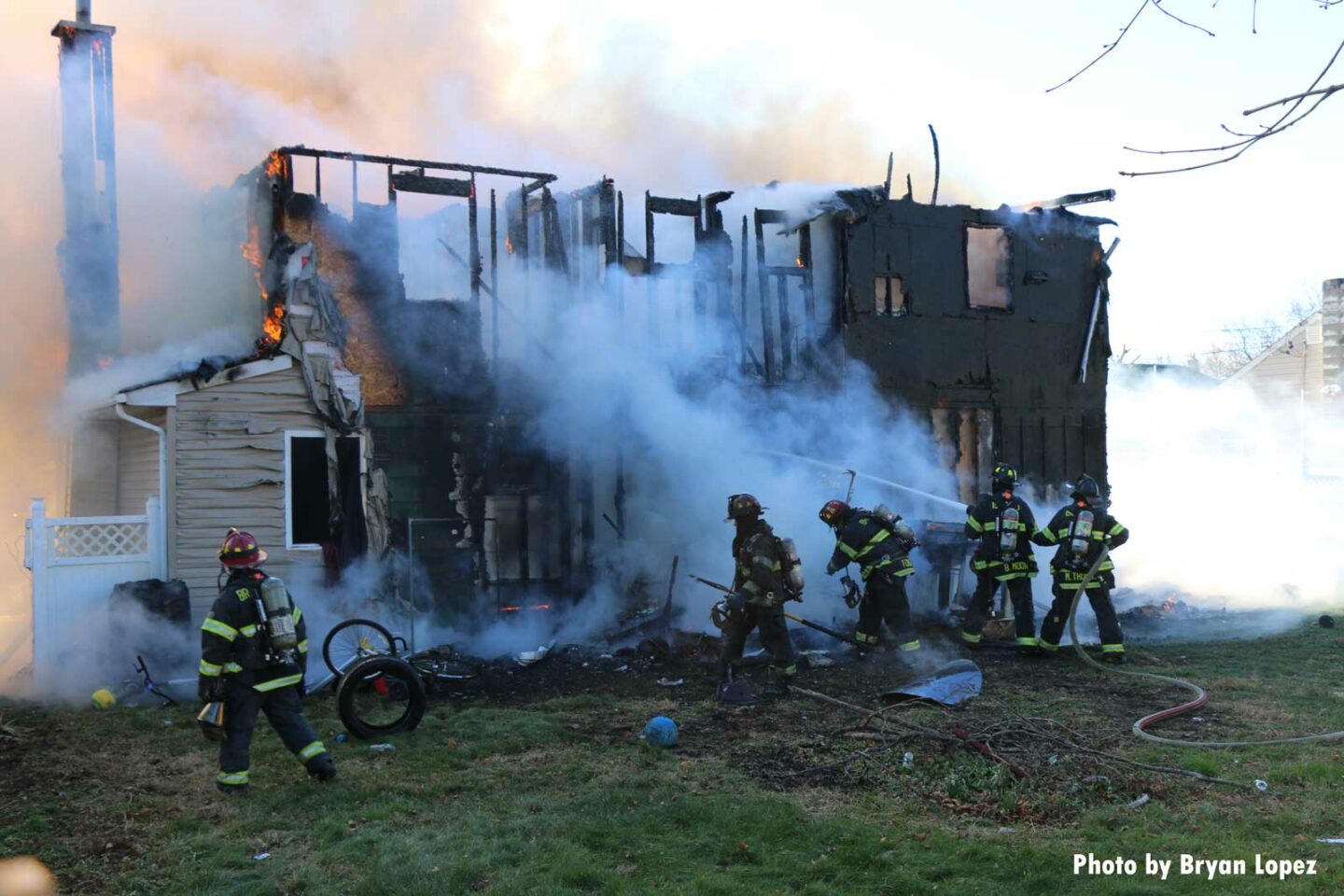 Smoke gusts from the charred remains of the home