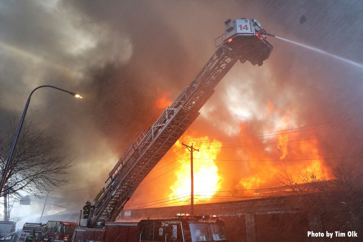 Chicago tower ladder flowing water onto commercial fire