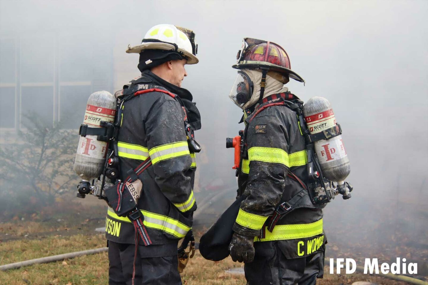 Firefighter and chief speaking at the fire scene