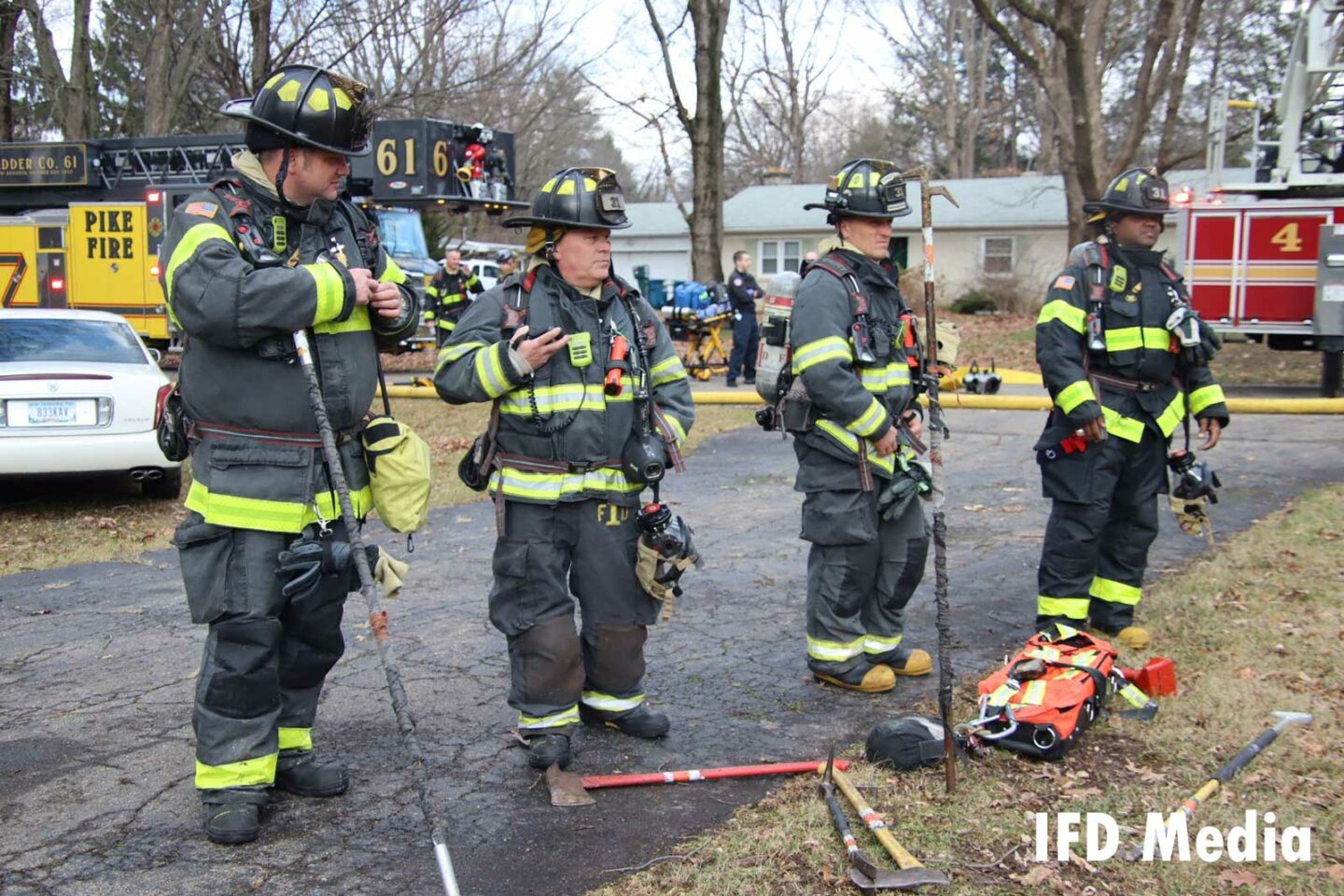 Four firefighters at work on scene at the house fire