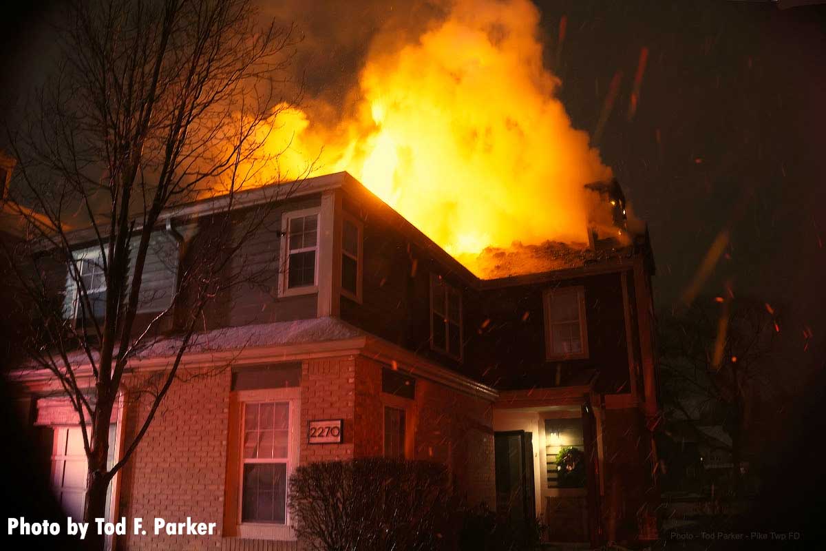 Flames erupt from the rear of the building