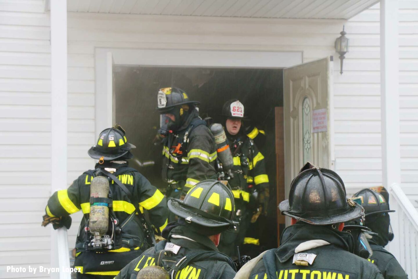 Firefighters congregate at door of church