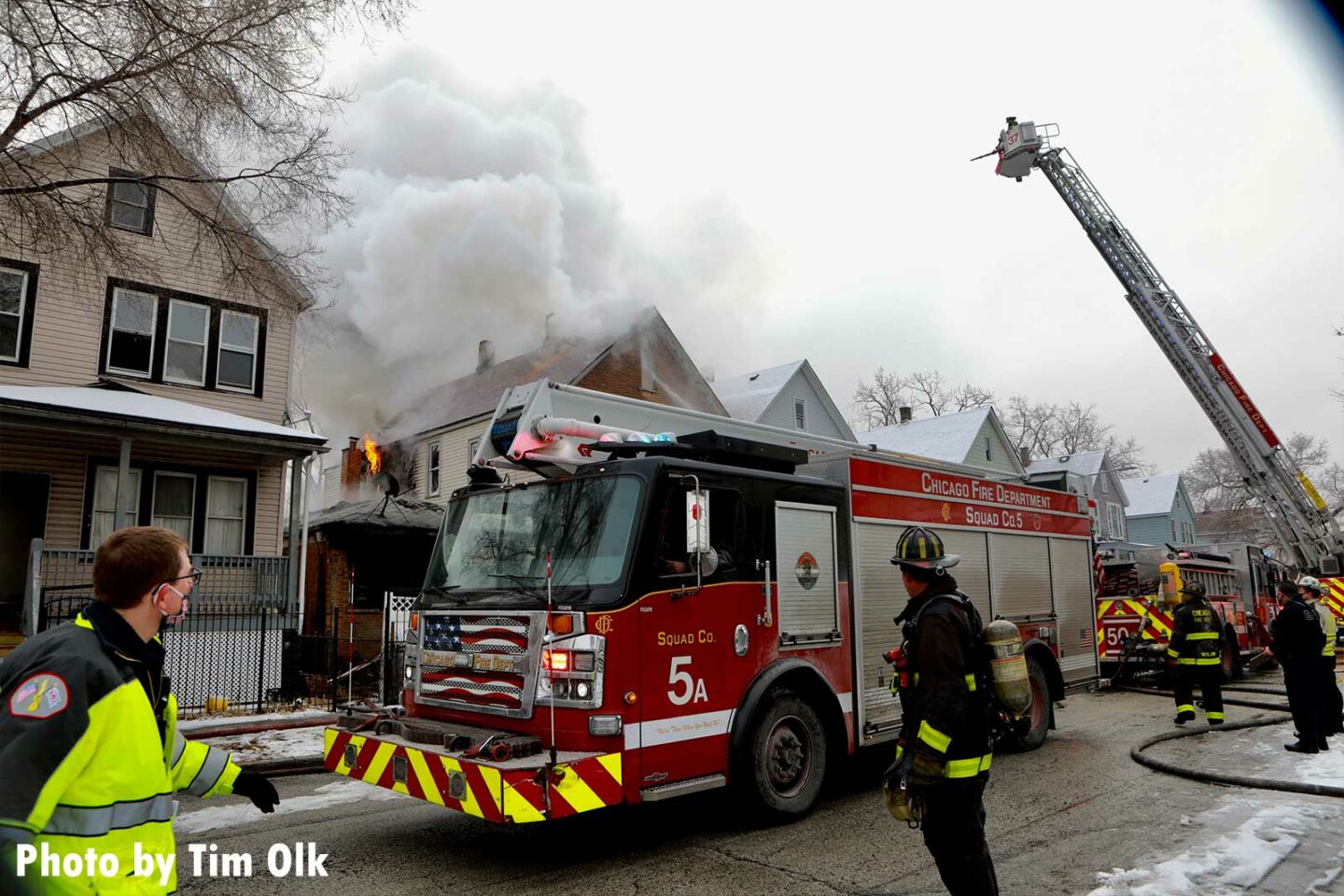 Chicago Tower Ladder raised in background with Squad 5 apparatus