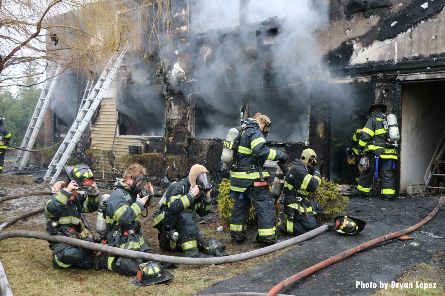 Firefighters at the scene of the Long Island house fire