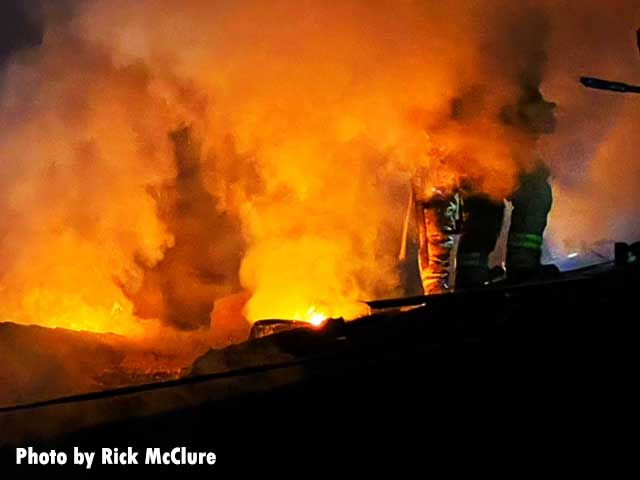 Firefighters in smoke on the roof