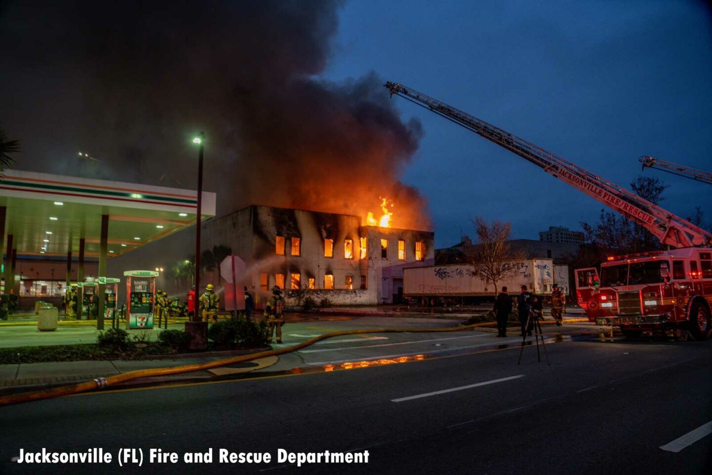 Flames shooting from a commercial building in Jacksonville as firefighters raised aerial