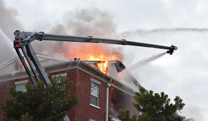 Flames shoot through roof of home as aerials work