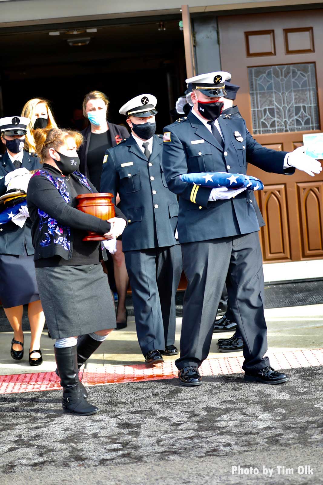 Urn and firefighter with folded flag at Al Schlick funeral