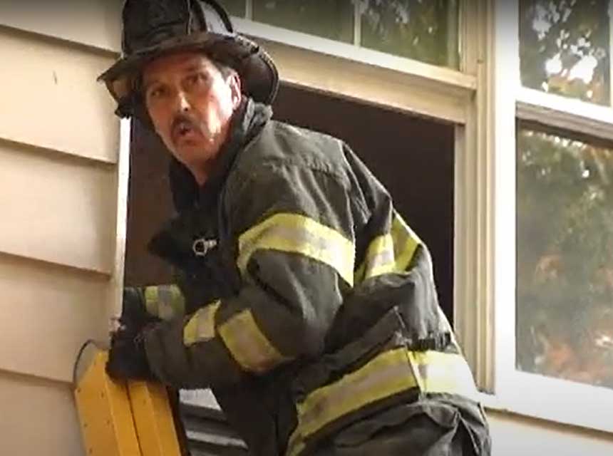 Mike Ciampo on a ladder going up to a window