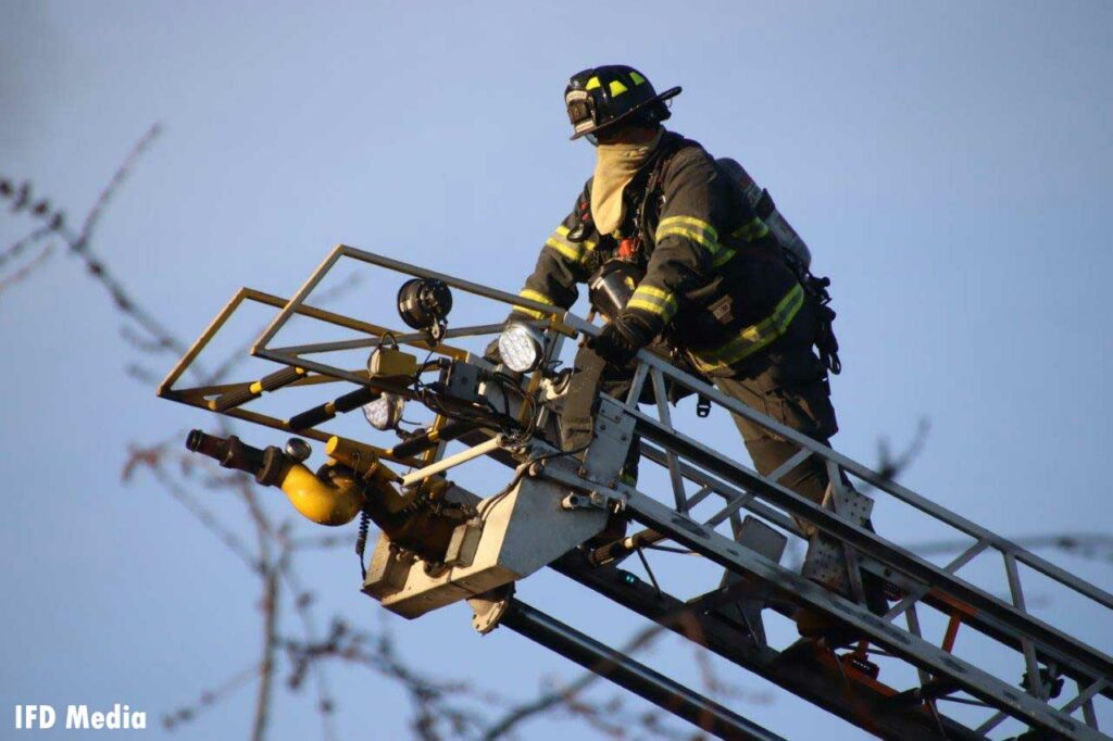 Firefighter at the tip of a straight stick waterway