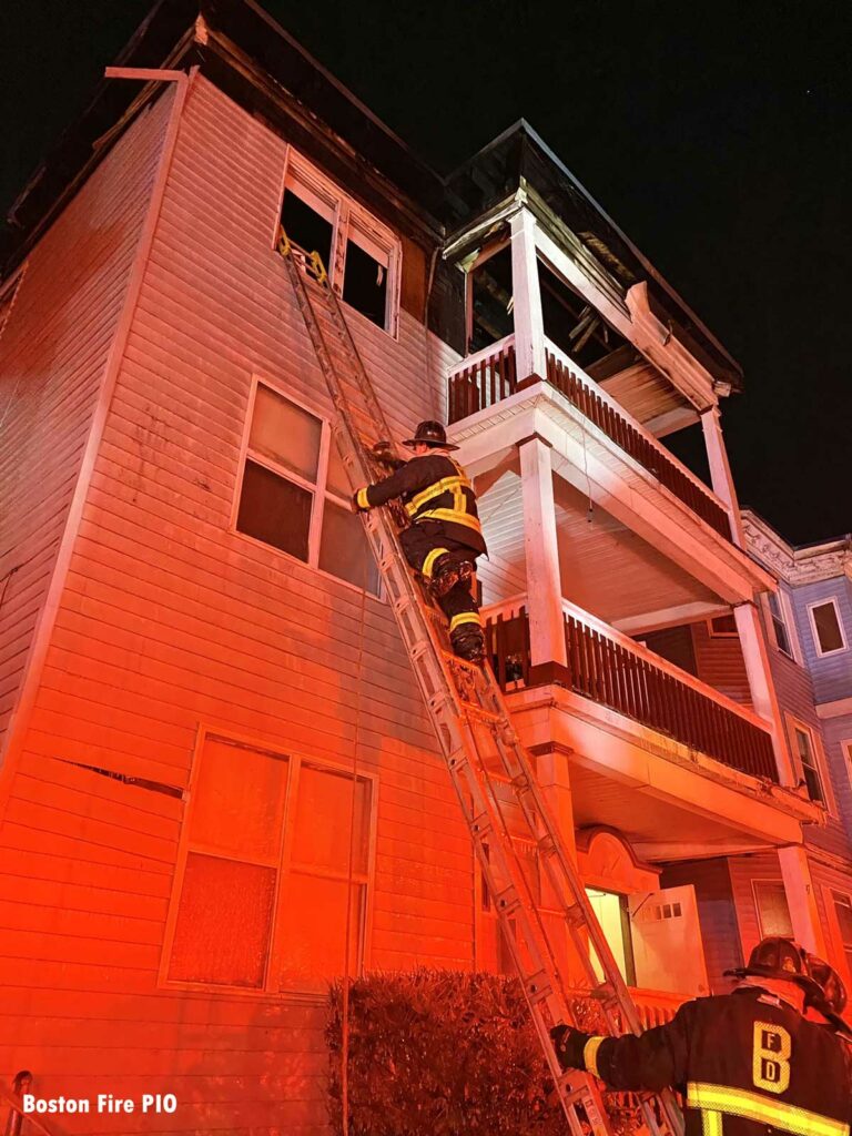 Boston firefighter on a portable ladder at the fire