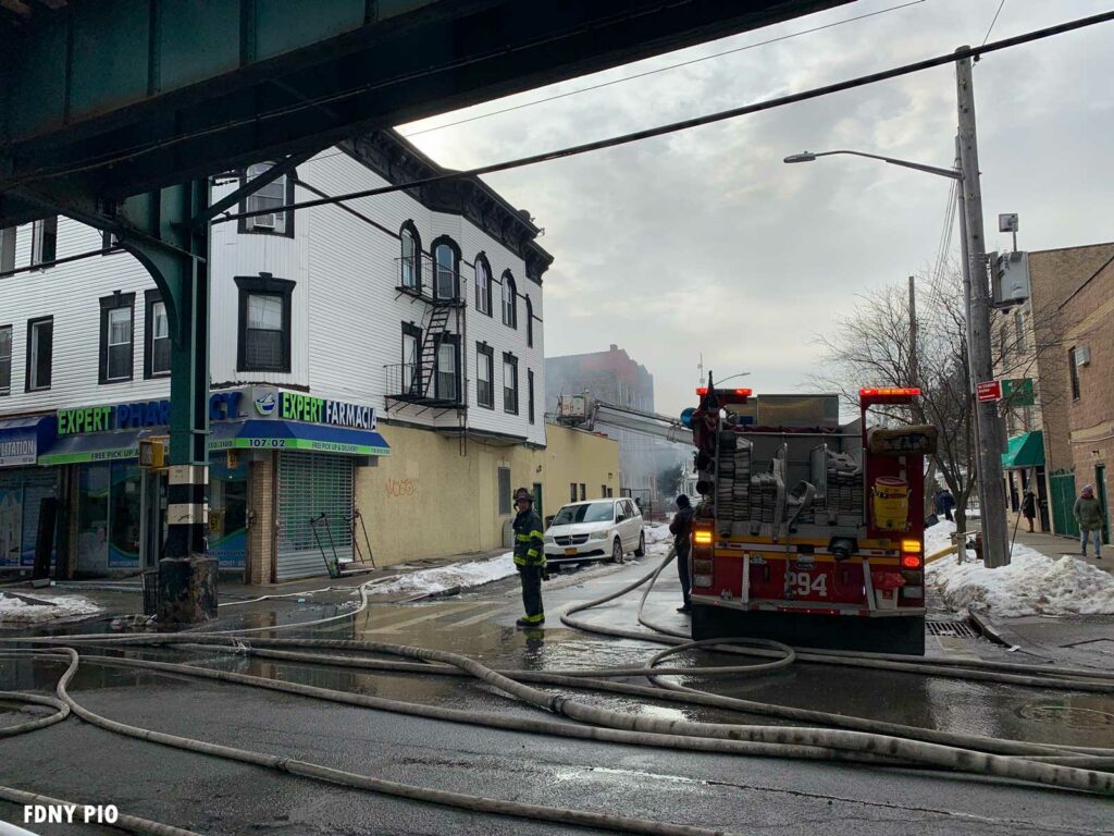 FDNY engine with hosebeds and hoselines in the street at fire in Queens