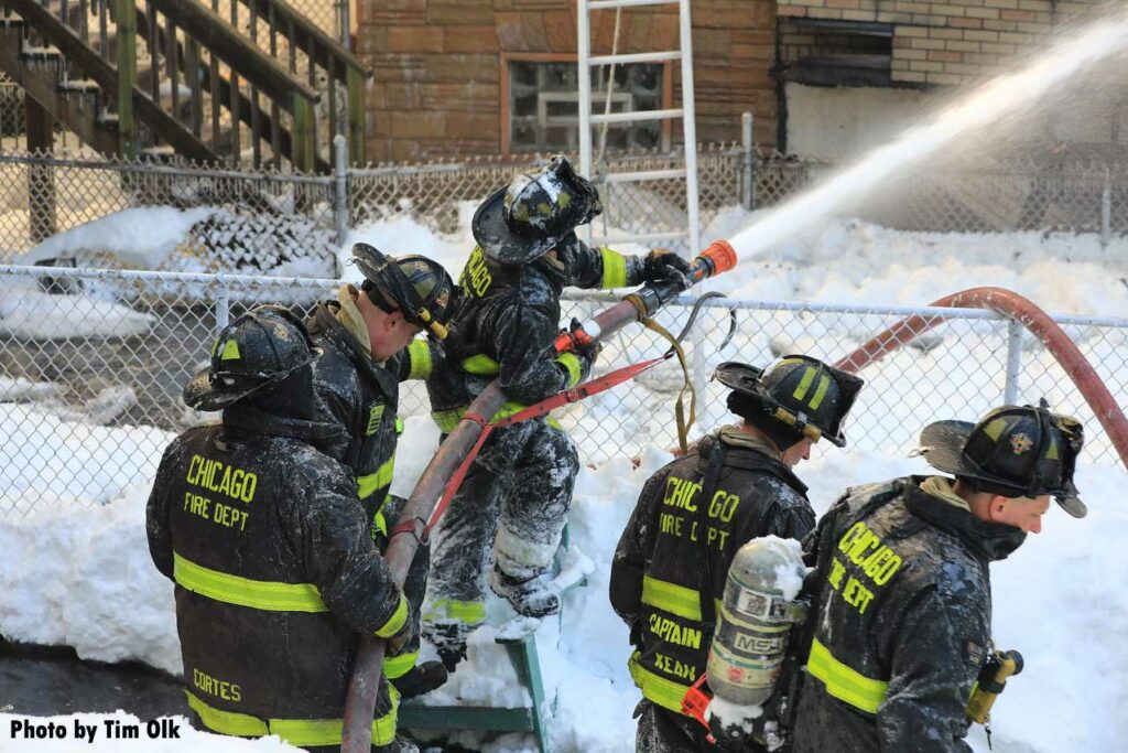 Chicago firefighters manipulate an exterior stream on the fire