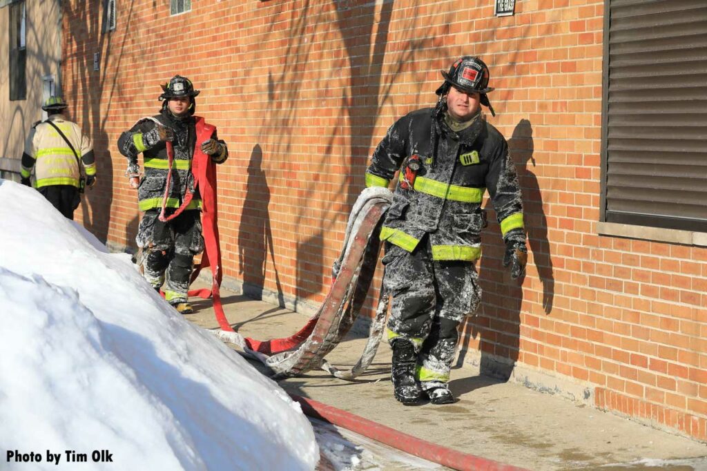 Chicago firefighters carrying hoselines