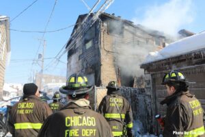 Multiple firefighters at the scene of a Chicago fire with Mayday