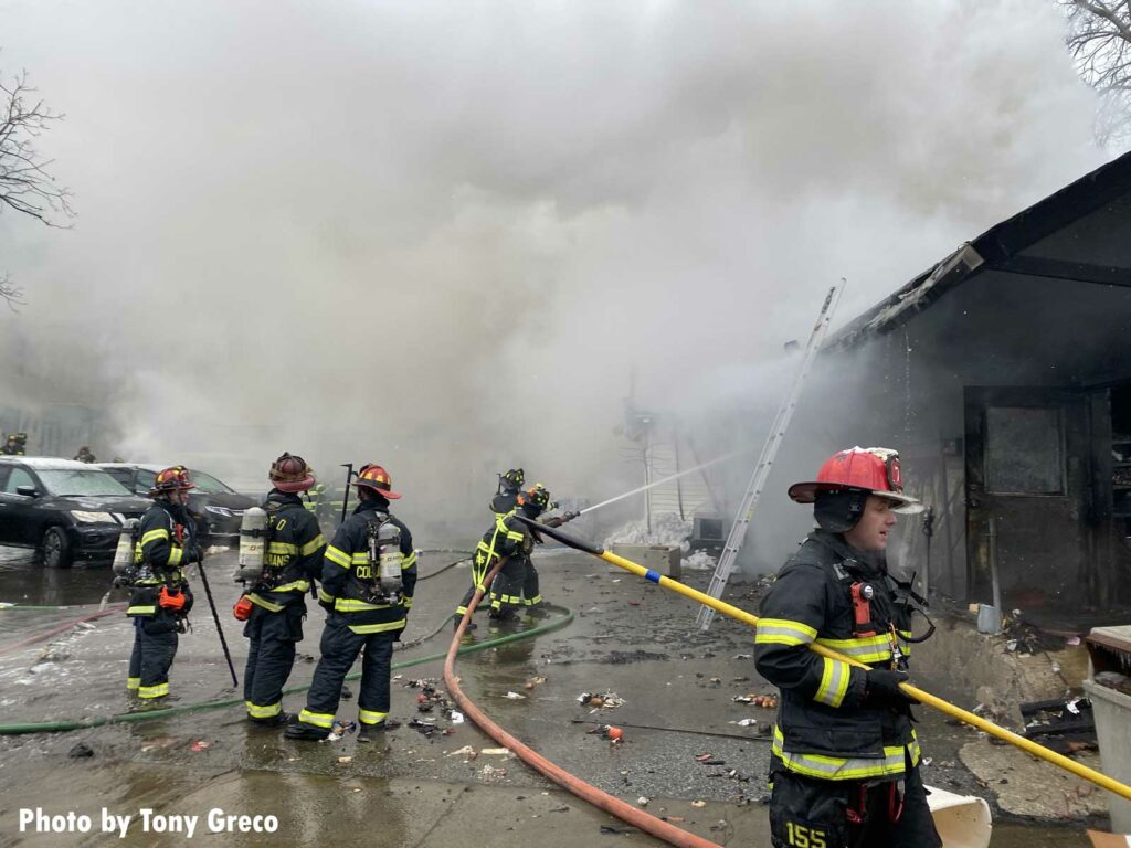 Firefighters apply water from the exterior of the supermarket