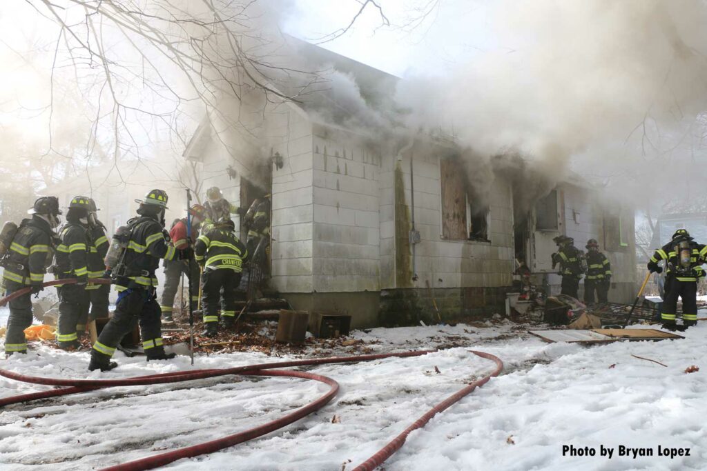 Firefighters operate at a house fire on Long Island