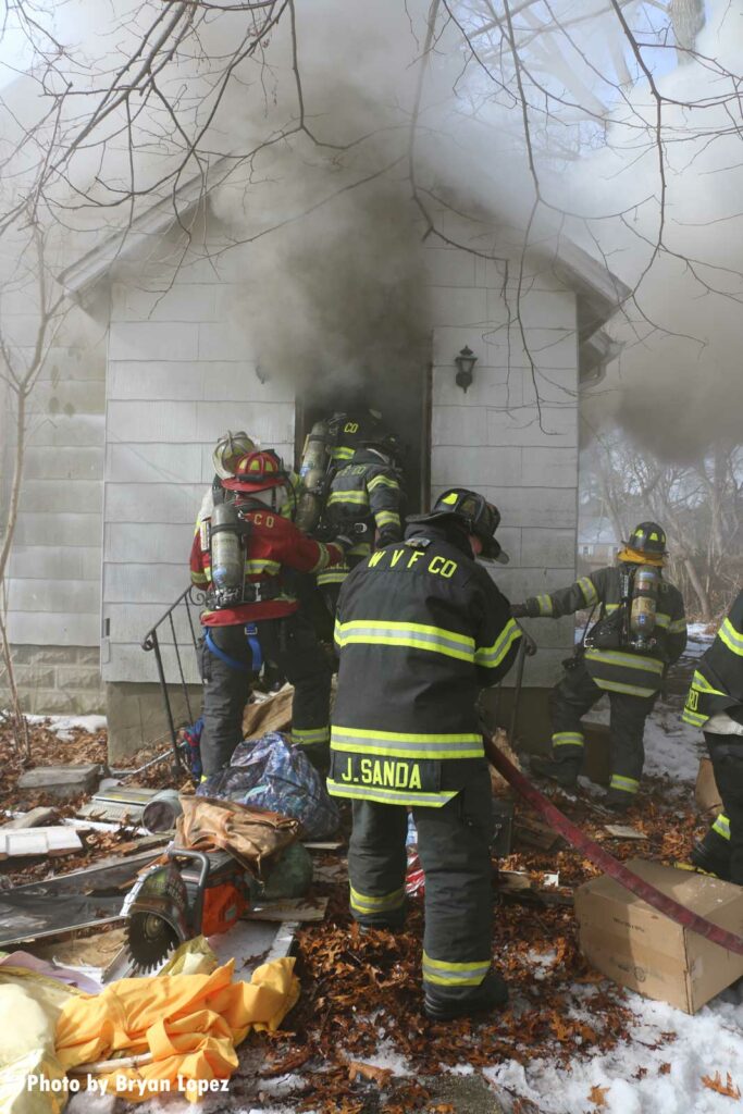 Firefighters make entry at house fire on Long Island