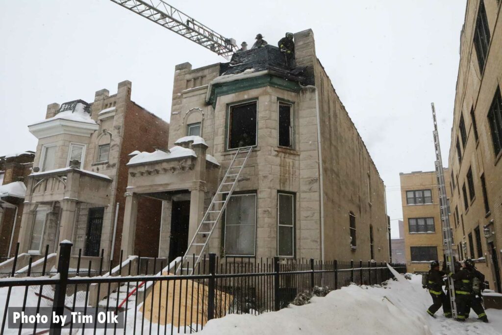 Chicago firefighters laddering a building