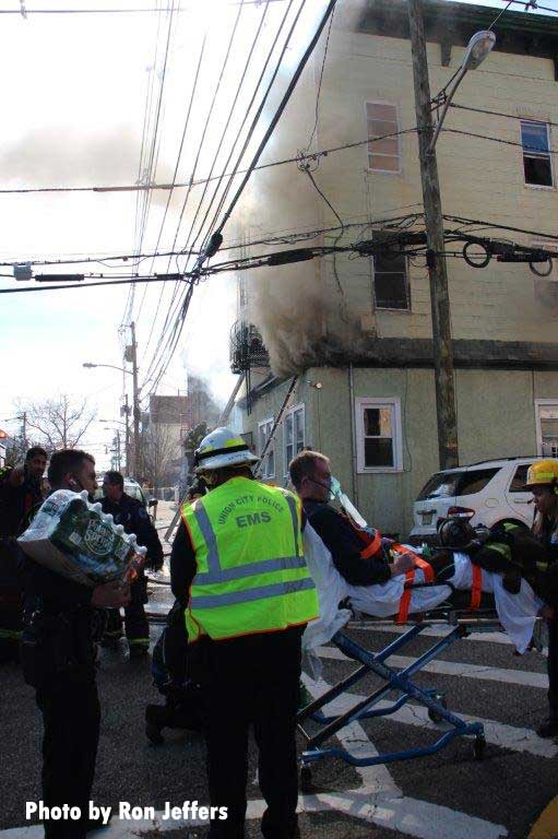 Smoke showing at the scene of a Union City fire with one person on a stretcher