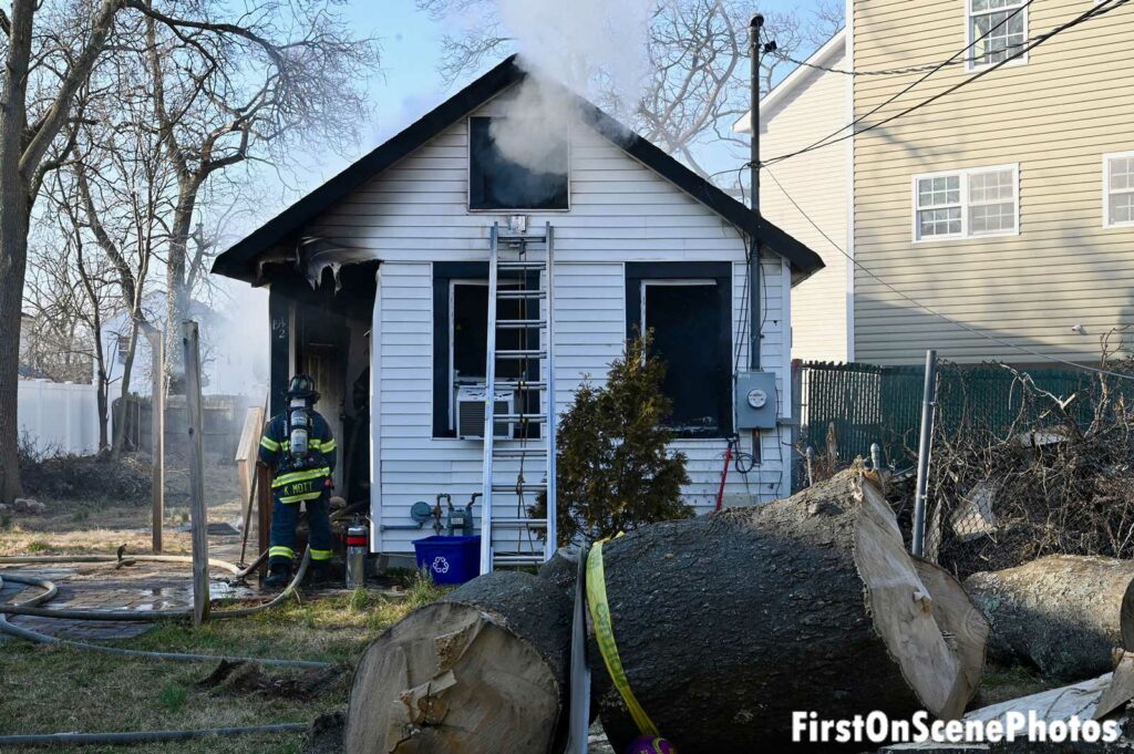 Ladder and firefighter at scene of Hempstead house fire