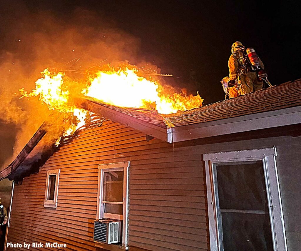 Flames shoot through the roof of a home in Sun Valley, Los Angeles