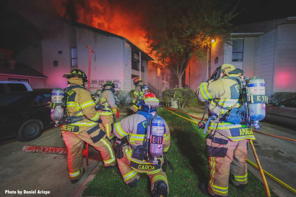 Cy-Fair firefighters mask up as flames rip through apartments in background