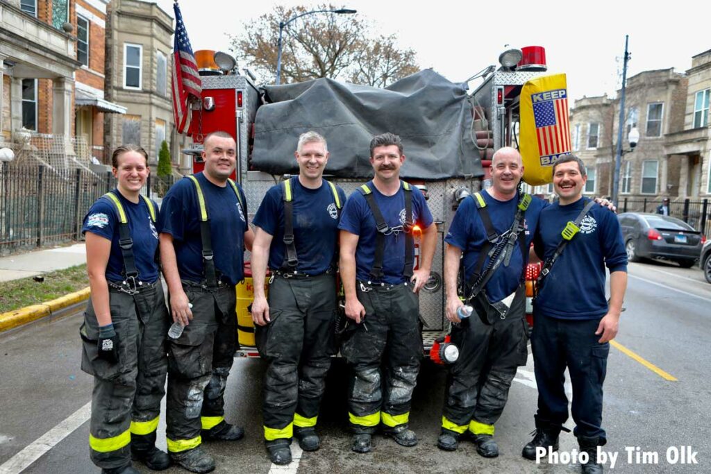 Chicago firefighters in front of fire apparatus