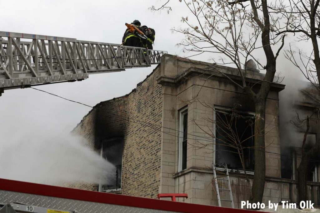 Chicago firefighter on an aerial ladder at fire scene