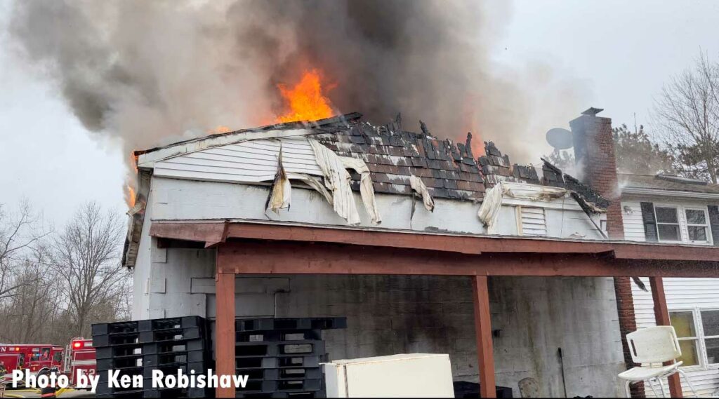 Flames rip along the roof of the building