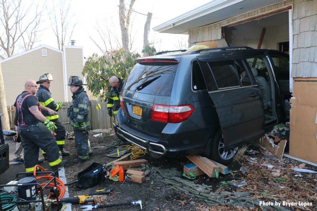 Firefighters perform extrication of car that barreled into home on Long Island