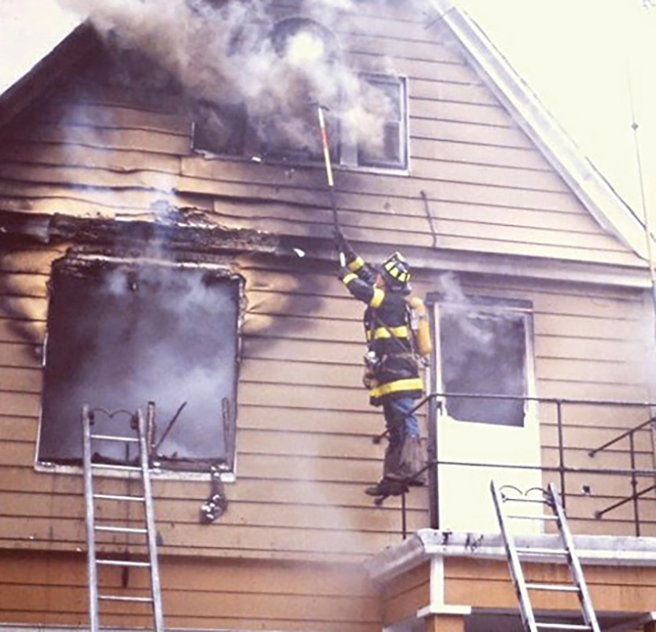 The outside vent firefighter takes the gable window at the right time to relieve conditions in the attic for the engine company attacking the fire.