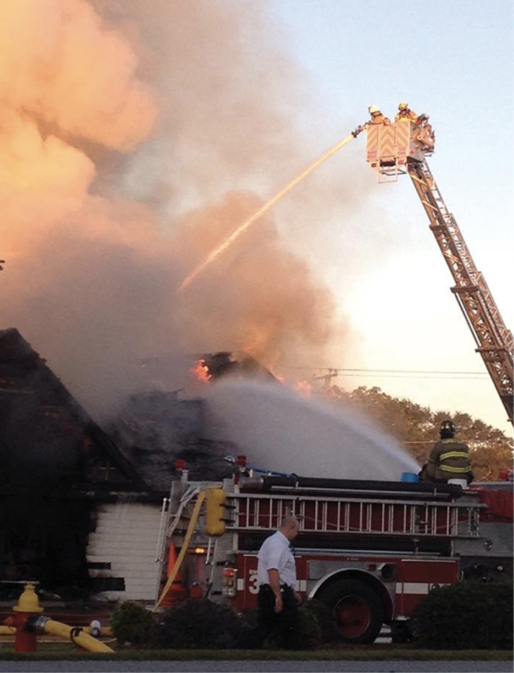 The 75-foot quint put an elevated master stream into the main body of fire, pushing away from the B side exposure occupancy.