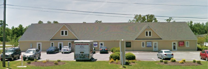 The building as it was rebuilt afterward. The fire occurred in the occupancy on the right (the A/D corner) side of the building, only a couple of feet away from the occupancy to the left whose tenant ran in to retrieve computer hard drives. <em class=