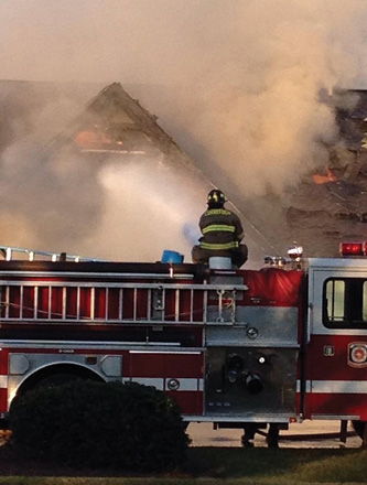 One of the first two firefighters to arrive on scene used the deck gun on this platform, the initial attack piece, to knock down a large portion of fire; it would quickly flare back up again.