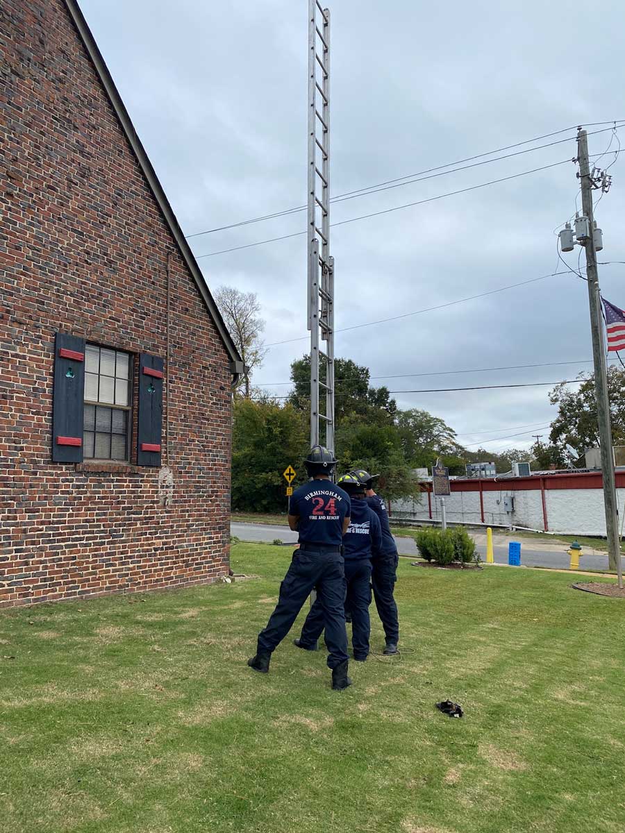 Firefighters raising a ladder