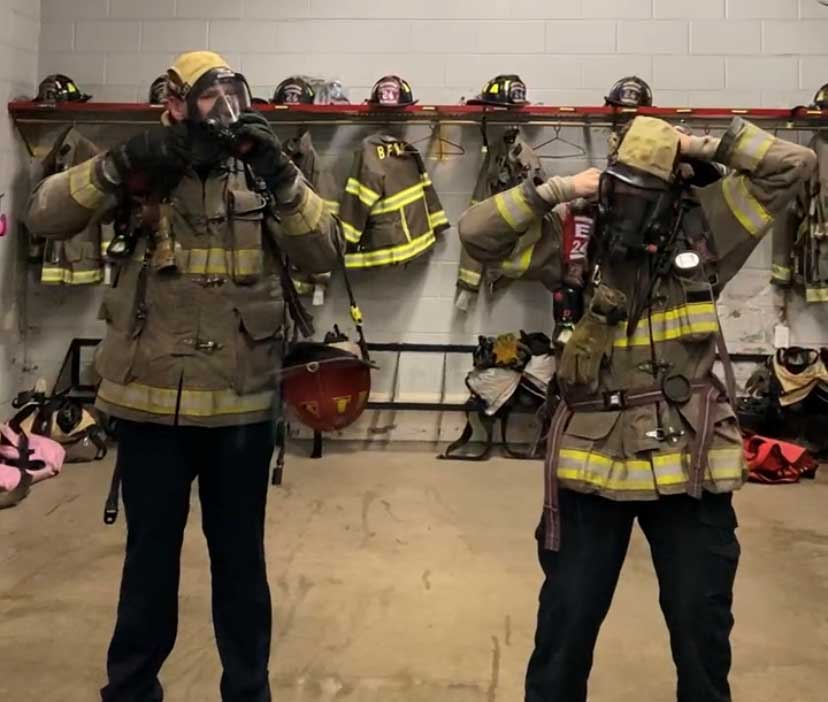 Firefighters masking up in station