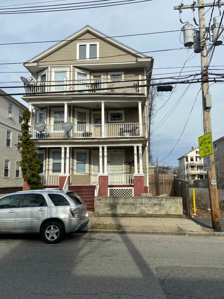 Power lines near a building with multiple porches