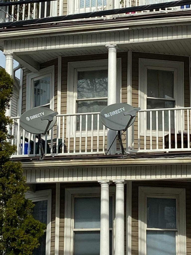 Multiple TV dishes on a porch